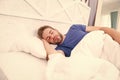 Tips sleeping better. Bearded man sleeping face relaxing. Maintaining consistent circadian rhythm is essential for