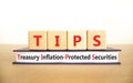 TIPS symbol. Concept word TIPS Treasury Inflation Protected Securities on beautiful blocks. Beautiful white background. Business Royalty Free Stock Photo