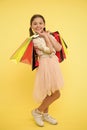 Tips to save money on back to school supplies and clothing. Back to school season teach budgeting basics. Girl carries Royalty Free Stock Photo