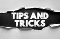 TIPS AND TRICKS message displayed under torn paper. Concept illustration for advice, guidance, instructions, shortcuts, solutions Royalty Free Stock Photo