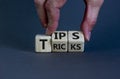 Tips and tricks symbol. Businessman turns cubes and changes the word `tricks` to `tips`. Beautiful grey background. Business,