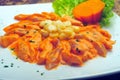 Peruvian recipe of fish tiradito with cooked corn, lots of yellow sauce