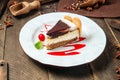 Tiramisu cake with berry sauce on the wooden table