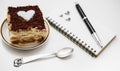 Tiramisu cake with heart and notepad