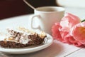 Tiramisu cake, pink tulips and cup of coffee on a white wooden table Royalty Free Stock Photo