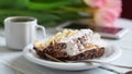 Tiramisu cake, pink tulips and cup of coffee on a white wooden table Royalty Free Stock Photo