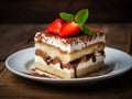 Tiramisu cake on white plate with slices of strawberry and min leaves on it. AI Generated Image