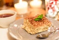 Tiramisu by candlelight, romantic date in Italy, tiramisu dessert on a porcelain plate