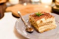 Tiramisu by candlelight, romantic date in Italy, tiramisu dessert on a porcelain plate