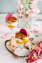 Tiramisu creme dessert with mango in a glass. Dessert and orchid decoration on the table