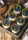 Tiramisu dessert with cinnamon, mint and blueberry in wooden tray