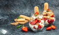 Tiramisu. Homemade tiramisu cake with fresh strawberry, mascarpone and mint in glass . Tiramisu portion on plate on dark Royalty Free Stock Photo