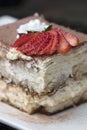 Italian Tiramisu made with chocolate and layers of cake and cream, topped with strawberries Royalty Free Stock Photo