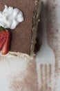 Italian Tiramisu made with chocolate and layers of cake and cream, topped with strawberries Royalty Free Stock Photo