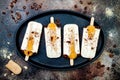 Tiramisu popsicles. Ice pops with italian savoiardi cookies and tiramisu ingredients on rustic kitchen table.