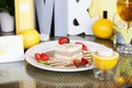 Tiramisu with strawberries on a plate lemon letter