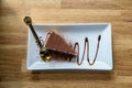 Tiramisu on white plate . Delicious Tiramisu cake with coffee beans and fresh mint on a plate on a light background.