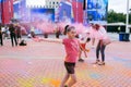 Holi festival. Young cheerful people under explosion of colored powder at Holi colors party. Royalty Free Stock Photo