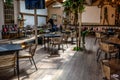 The waiter serves the table in the Season Restaurant and Pizza in Tirana. Vintage interior of a Royalty Free Stock Photo