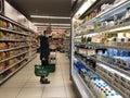 Young woman shopping in a grocery store and wearing protective mask. Royalty Free Stock Photo