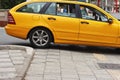 Tirana, Albania - September 1th 2022: Yellow taxi on the street of Tirana, Albania. Albanian taxi in the center on Tirana city.