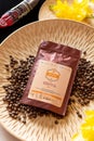 Tiraspol, Moldova - March 19, 2021: AA grade coffee. Kenya - 100% Arabica, local Barista brand on wooden decorative plate and