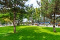 Tiraspol, Transnistria, Moldova - September 6, 2022: city park, green lawns and trees, random people walking along the paths, Royalty Free Stock Photo