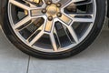 Tire and alloy wheel of a modern car on the ground, car exterior details Royalty Free Stock Photo