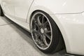 Tire and alloy wheel of a modern white car on the ground. car exterior details Royalty Free Stock Photo