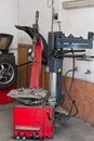 Tire changer device in an automobile repair shop Royalty Free Stock Photo