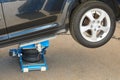 Tire fitting with pneumatic jack