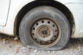 Tire leak, close up wheel of old white vintage car. Car wheel flat tire on the road. Deflated the tyre of an old car next to a Royalty Free Stock Photo