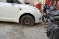 Tire leak, close up wheel of old white vintage car. Car wheel flat tire on the road. Deflated the tyre of an old car next to a Royalty Free Stock Photo