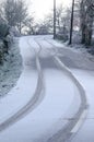 tire marks on a snow covered road Royalty Free Stock Photo