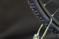 Tire of a mountain bike on a black background close-up. Stand for the repair of wheels. Bicycle repair Royalty Free Stock Photo