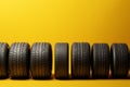 Tire row elegance Yellow background adorned with a neat row of tires