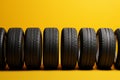 Tire row elegance Yellow background adorned with a neat row of tires