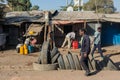 Tire salesman on a busy street with various informal shops in th