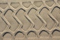 Tire sample in the sand. Background with beige fine sand. Sand surface on the beach, view from above.