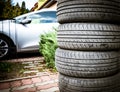 Tire stack background. Selective focus. Car in the background Royalty Free Stock Photo