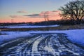 Tire Track Puddles with Sunset Pinks in Sky Royalty Free Stock Photo