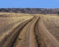 Tire track and ruts in dirt road Royalty Free Stock Photo