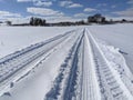 Tire Tracks Across Snowy Field