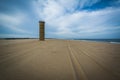 Tire tracks on the beach and a World War II Observation Tower at Royalty Free Stock Photo