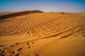 Tire tracks through the desert sand dunes. Royalty Free Stock Photo