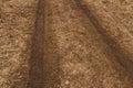 Tire tracks in a field on the path.A car footprint. Close-up Royalty Free Stock Photo