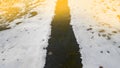 Tire tracks in the melting snow on asphalt road Royalty Free Stock Photo