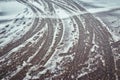 Tire tracks in the melting snow on asphalt road Royalty Free Stock Photo