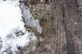 Tire tracks on the sand. Wheel tracks on dirt. Dark tire tracks background with snow and water. Wheel track on muddy Royalty Free Stock Photo