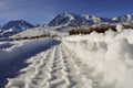 Tire Tracks in Snow Afoot large Peaks and Mountains snow covered Royalty Free Stock Photo